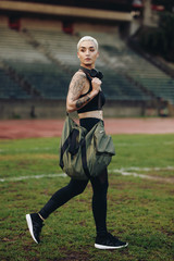 Obraz premium Fitness woman walking inside a track and field ground