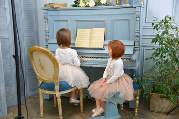 Cute little girl plays piano. Education, lesson