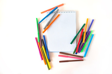 Obraz premium Multicolored felt pens with notebook isolated on white background. Recreation concept drawing