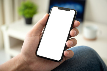 woman hand holding phone with isolated screen in room house