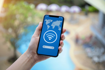 female hand holding phone with app search for free wi-fi
