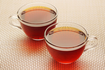 Two glass cups with black tea