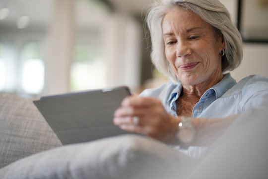  Senior Woman At Home With Tablet