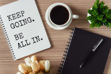 Inspirational and motivation life quote on notepad - Keep going, be all in.