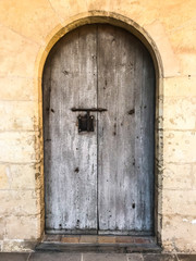 Fototapeta na wymiar Wooden vintage doors in wall of an old building