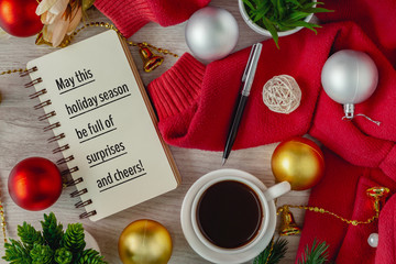 Notepad with season's greetings wish and ornament balls decoration. Merry Christmas and holiday concepts.