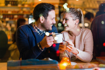 Young attractive couple on date in bar