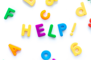 Help spelled with colorful magnetic letters on a white background