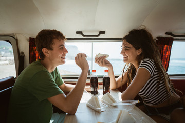 couple of caucasian man and woman sitting enjoy a meal
