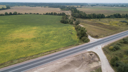 Aerial view of a road in a green field