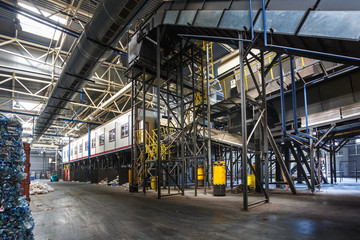 Fototapeta premium metal constructions of garbage sorting conveyor on modern waste recycling processing plant. Separate garbage collection. Storage of waste for further disposal.