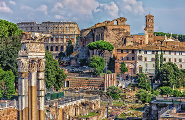 Fototapeta na wymiar The Roman forum, view on the Coliseum, the Temple of Venus Genetrix Ruins, The Temple of Venus and Roma and the Tower of the Militia on the background