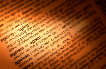 CLOSE UP OF DICTIONARY PAGE SHOWING DEFINITION OF THE WORD AGEING