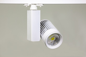 Lamp LED white Track light for lighting of exhibition spaces and shops. White lamp on white background for catalog. New technologies. IT technology