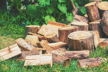 Firewood for heating in winter. Pile of cutting pine wood outdoors