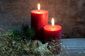 Adventsdekoration mit roten Kerzen und goldener Dekoration