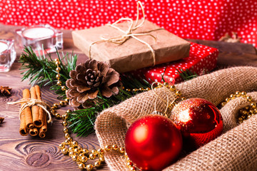 Fototapeta na wymiar Christmas and New Year background. Christmas gift wrapped in kraft and colored paper, decorated on a wooden table.