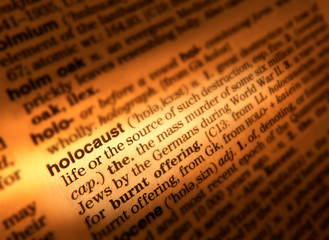 CLOSE UP OF DICTIONARY PAGE SHOWING DEFINITION OF THE WORD HOLOCAUST