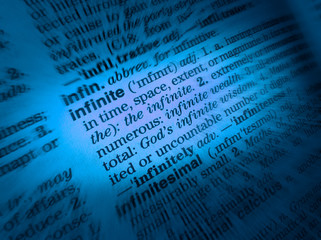 CLOSE UP OF DICTIONARY PAGE SHOWING DEFINITION OF THE WORD INFINITE