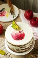 Apple cake with curd cream, decorated with painted apple on the background of autumn composition. Rustic style.