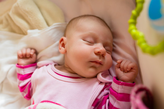 An Overhead View Of Cute Newborn Baby Sleeping In The Crib