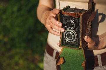 Vintage analog camera in the hands of the photographer. Ready to shoot