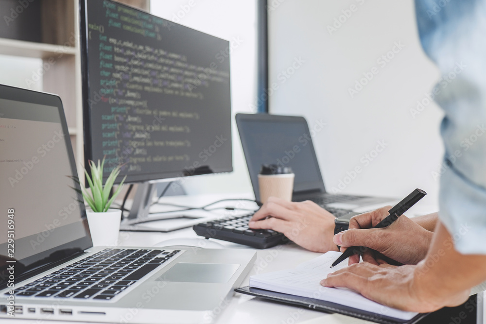 Aufkleber writing codes and typing data code technology, programmer cooperating working on web site project in