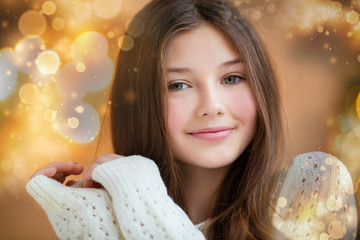 Fototapeta premium Portrait of beautiful girl with long hair wearing warm winter clothes in Christmas interior.