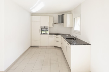 Fototapeta na wymiar White kitchen in empty apartment