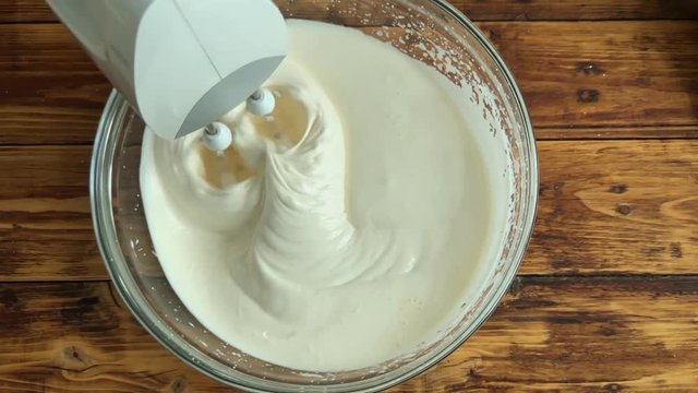 Woman mixing egss with flour for apple pie dought, top view slow motion video