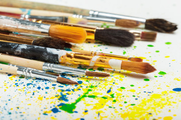 Fototapeta premium paintbrushes and water-color abstract art close up