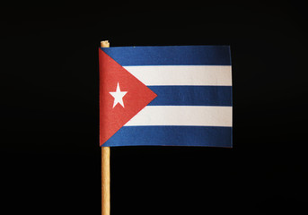 A national flag of Cuba on toothpick and on black background. Cuba is famous for criminality and import and export drugs and cigars