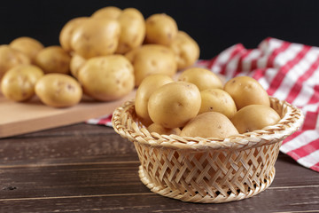 Fresh potatoes on the wood background