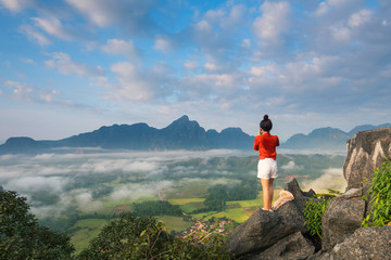 Young girl travels on high mountain in Vang-Vieng, Laos.