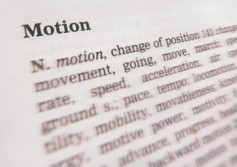CLOSE UP OF DICTIONARY PAGE SHOWING DEFINITION OF THE WORD MOTION