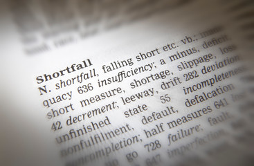 CLOSE UP OF DICTIONARY PAGE SHOWING DEFINITION OF THE WORD SHORTFALL
