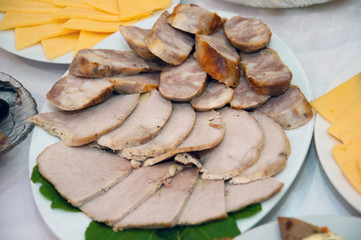 Meat sliced. Meat and sausage cut into pieces. Festive table, food, holiday new year, christmas