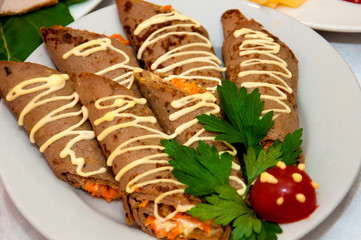 Pancakes from the liver with carrots and mayonnaise. Festive, New Year's dish in restaurants. Celebration of the New Year, Christmas, Birthday