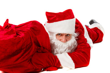 Santa Claus is lying with a bag of gifts.
