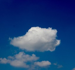 The white cloud in the bright blue sky.