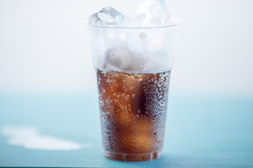 A glass of water, a close-up view of cold ice, a glass of soft drinks (soft drinks, alcohol, nectar) placed on a wooden table, managed by the client or eaten to refresh the body.