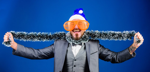 Guy tinsel ready celebrate new year. Corporate party ideas employees will love. Corporate christmas party. Man bearded cheerful hipster wear santa hat and funny sunglasses. Christmas party organisers