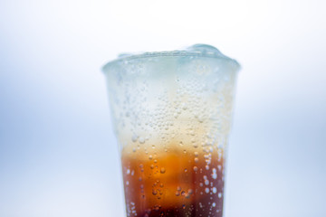 A glass of water, a close-up view of cold ice, a glass of soft drinks (soft drinks, alcohol, nectar) placed on a wooden table, managed by the client or eaten to refresh the body.