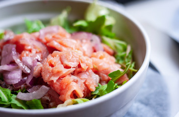 Smoked salmon salad with red onion in restaurant in Syracuse, Sicily, Italy