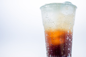 A glass of water, a close-up view of cold ice, a glass of soft drinks (soft drinks, alcohol, nectar) placed on a wooden table, managed by the client or eaten to refresh the body.