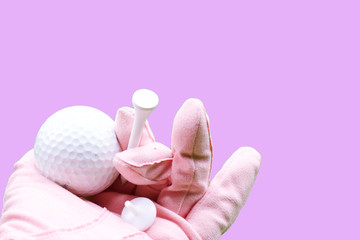 Hand of lady golfer is holding tee and golf ball 