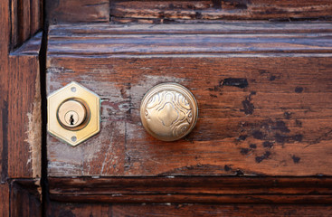 Exterior vintage door handle and lock on a front door of ancient building in Catania, Sicily, Italy