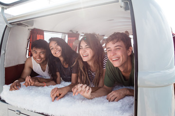 group of young people smiling lay down