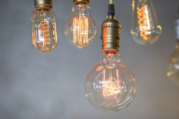 Beautiful hanged orange decoration light bulbs focus on pear shape like one in the coffee shop