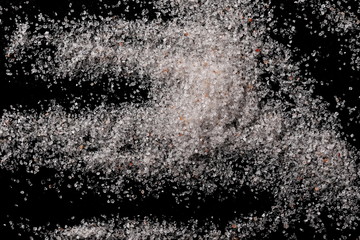 Himalayan salt pile isolated on black background, top view